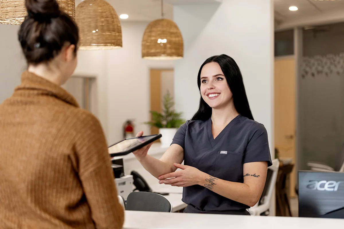 Friendly front desk staff welcoming a patient at Miller Dental Care