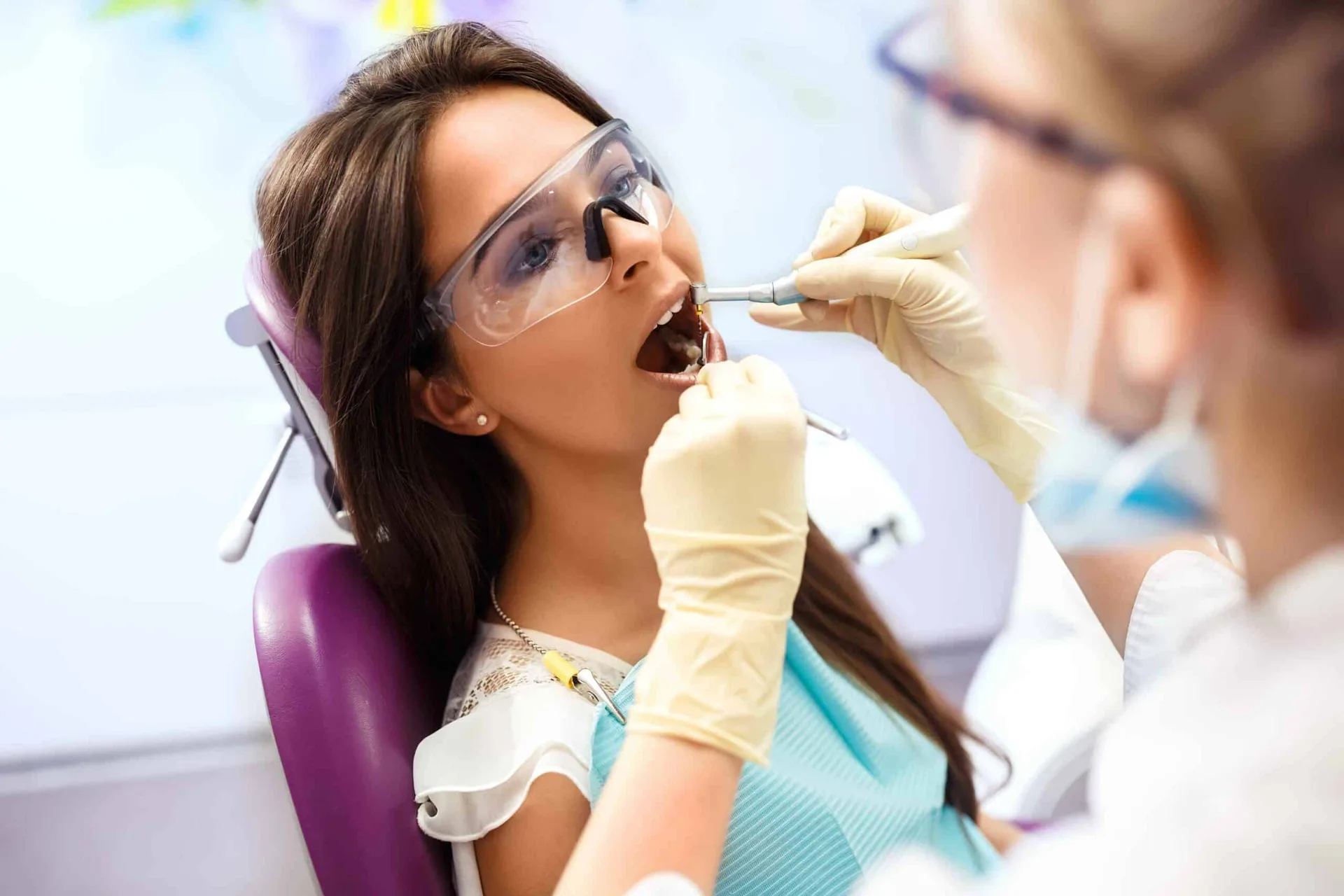 Dentist performing restorative dental care including root canal treatment